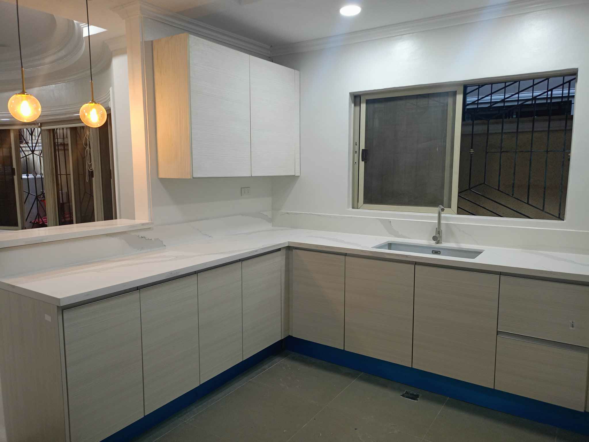 Blue kitchen with white backsplash